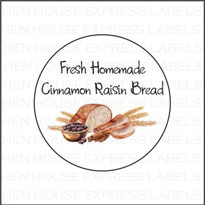 May include: A round white label with a black border, featuring a watercolor illustration of cinnamon raisin bread, wheat stalks, and cinnamon sticks. The text "Fresh Homemade Cinnamon Raisin Bread" is printed in black.