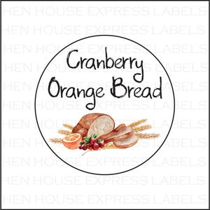 May include: A round white label with a black border. The label has a watercolor illustration of cranberry orange bread with wheat stalks. The text "Cranberry Orange Bread" is written in black cursive.