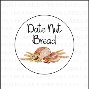 May include: A white round label with a black border. The label has the text "Date Nut Bread" written in black cursive font. There is a watercolor illustration of sliced bread, wheat stalks, and nuts.