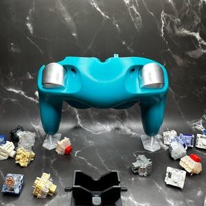 Our Low Gloss Silver Trigger Caps and Satin Black Rumble Bracket, under direct lighting.