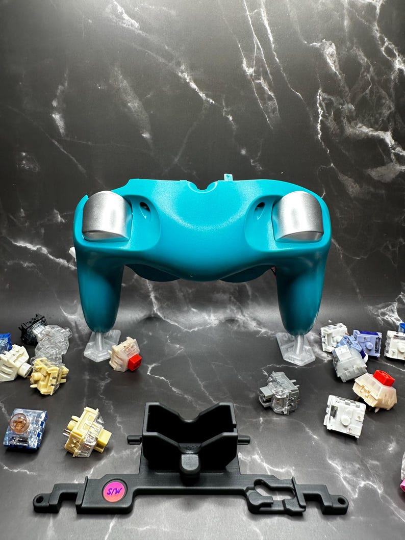 Our Low Gloss Silver Trigger Caps and Satin Black Rumble Bracket, under direct lighting.