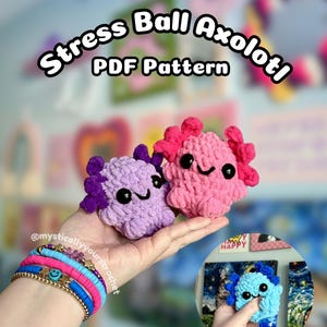 May include: Two crocheted axolotl stress balls, one pink and one purple, are held in a hand. The axolotls have black eyes and pink or purple gills. The text "Stress Ball Axolotl PDF Pattern" is at the top.