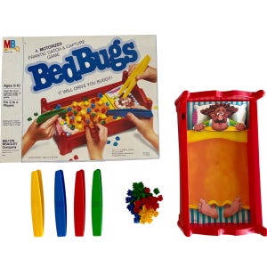 May include: A vintage Milton Bradley "Bed Bugs" board game. The box features the game's title in blue, with a red bed and colorful bugs. Includes a red bed-shaped game board, tweezers, and plastic bugs. For ages 6-10.