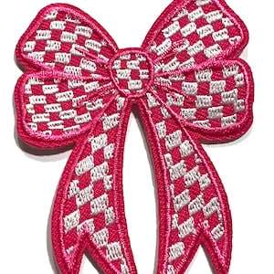 May include: Pink and white checkered bow with a satin finish. The bow is embroidered with a checkered pattern.