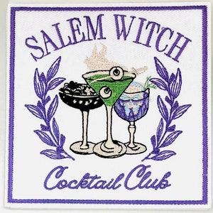May include: Embroidered patch with the words "Salem Witch Cocktail Club" in purple script. The design features three cocktail glasses, one green with eyeballs, surrounded by a purple laurel wreath on a white background.