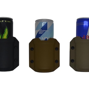 May include: Three beverage can holders in black, brown, and tan. Each holder has a can of energy drink inside. The black holder has an Apple Kiwi can, the brown holder has a blue and white can, and the tan holder has a Red Bull can.