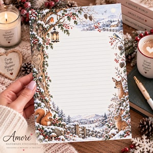 May include: A sheet of lined stationery featuring a winter forest scene with a snow-covered tree, a lantern, a robin, a deer, and a rabbit. The tree trunk has a heart-shaped carving with the text Gra. The border includes holly berries and pinecones.
