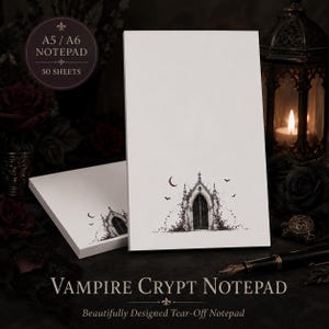 May include: A white notepad with 50 sheets, featuring a black and white illustration of a gothic arched doorway, vines, a crescent moon, and bats. The text on the notepad reads A5 / A6 NOTEPAD 50 SHEETS and VAMPIRE CRYPT NOTEPAD.