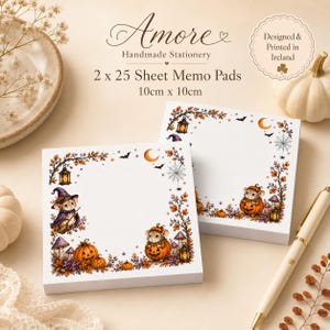 May include: Two square memo pads, each with 25 sheets, measuring 10cm x 10cm. The paper features a border illustration of mice in Halloween costumes, pumpkins, lanterns, spiderwebs, and autumn leaves. Text reads Amore Handmade Stationery.