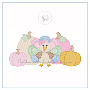 May include: An embroidered design featuring a turkey with a pink bow, surrounded by pink, tan, and yellow pumpkins. The text "Cotton Stitch Designs" is visible on the pumpkins. The design is set against a white background.
