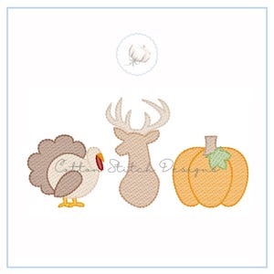 May include: Embroidered designs of a turkey, deer head, and pumpkin. The turkey is beige and brown with a red wattle. The deer head is beige with large antlers. The pumpkin is orange with a green stem. The text "Cotton Stitch Designs" is visible.