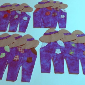 May include: A collection of twelve fabric scarecrow cutouts, each featuring a tan hat, purple mottled overalls with various patterned patches, and light green or white pocket accents. These decorative shapes are arranged in four groups.