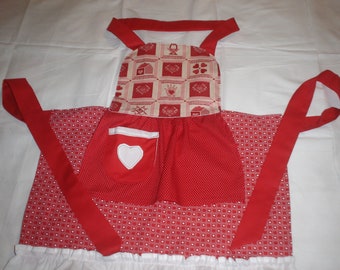 Child’s apron size 7-8 red & white w/hearts  Item #48