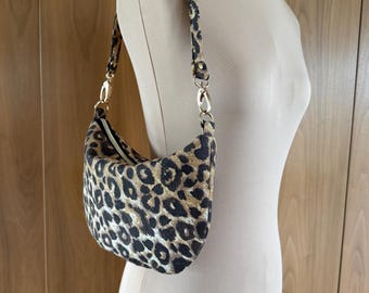 Wildly Chic: Slouchy Leopard Print Shoulder Bag with Gold Hardware