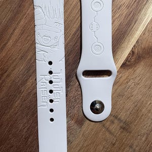 Anime themed engraved design on a silicone watch band compatible with Apple Watch and Samsung Galaxy Watch.