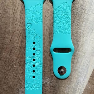 Anime grass and poison character themed engraved design on a silicone watch band compatible with Apple Watch and Samsung Galaxy Watch.