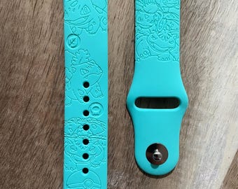 Anime grass and poison character themed engraved design on a silicone watch band compatible with Apple Watch and Samsung Galaxy Watch.