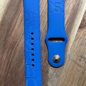 Anime themed engraved design on a silicone watch band compatible with Apple Watch and Samsung Galaxy Watch.