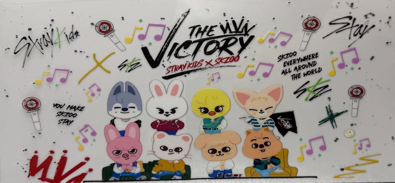 May include: A white background features cartoon character illustrations of SKZOO, the Stray Kids characters, with musical notes and text. The text includes "The Victory" and "SKZOO everywhere all around the world."