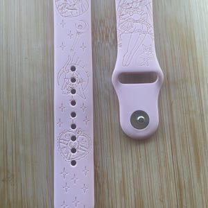 Cute moon girl themed engraved design on a silicone watch band compatible with Apple Watch and Samsung Galaxy Watch.