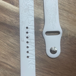 Anime themed engraved design on a silicone watch band compatible with Apple Watch and Samsung Galaxy Watch.