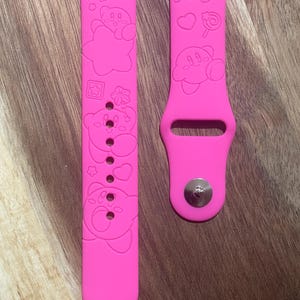 Cute pink puff themed engraved design on a silicone watch band compatible with Apple Watch and Samsung Galaxy Watch.