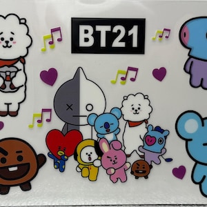 May include: A sheet of stickers featuring BT21 characters. The stickers include cartoon figures in various colours, such as yellow, white, red, and blue. Musical notes and purple hearts are scattered around the characters.