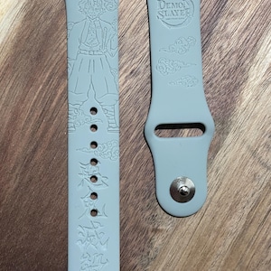 Anime themed engraved design on a silicone watch band compatible with Apple Watch and Samsung Galaxy Watch.