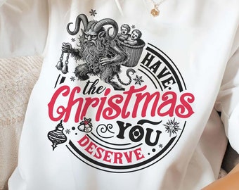 May include: White sweatshirt with a black and white illustration of a creature holding a basket with two children. The text "Have the Christmas you deserve" is printed in a circle around the illustration.