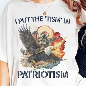 I Put The “Tism” In Patriotism Eagle Raccoon Shirt, Proud Patriotic USA Shirt, Autism Awareness Patriotic Tee, Neurodivergent Patriotic Tee
