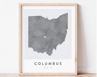May include: A framed print of a gray watercolor map of Ohio with a white heart marking the location of Columbus. The print has the text "COLUMBUS OHIO" below the map.