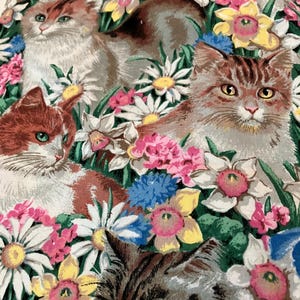 May include: A fabric print featuring multiple cats with various fur patterns nestled among a dense garden of white daisies, yellow daffodils, pink flowers, and blue cornflowers. The cats have distinct eye colors including green, yellow, and blue.