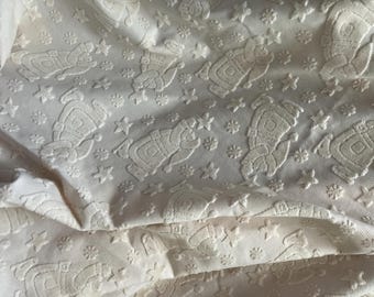 Raised Flying Santa Catching Stars, Cream upholstery Type Fabric. Medium Weight