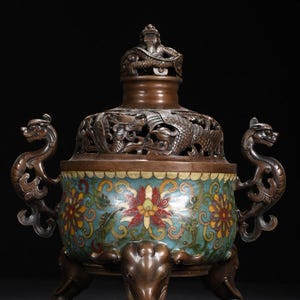 May include: A set of three ceramic mugs with a speckled, cream-colored glaze. Each mug features a different hand-painted floral design in shades of blue, green, and yellow. The mugs have a simple, rounded shape and a comfortable handle.