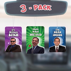 May include: Three car air fresheners featuring images of the character Michael Scott from the TV show The Office. The air fresheners have the following text: "It's Britney Bitch", "Thats what she said", and "I'm Dead Inside".