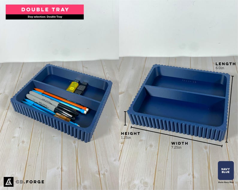 May include: A navy blue double tray with a ribbed exterior design. The tray features two rectangular compartments. Dimensions are labeled as 7.25 inches in width, 6.0 inches in length, and 1.25 inches in height. Pens and USB drives are inside.