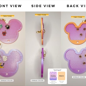 May include: Two Mickey-shaped pin display boards with grid holes. One is two-tone pink and orange, the other is single-color lavender. Both feature gold-tone lobster claw clasps and small enamel pins attached to the front. Text includes FRONT VIEW, SIDE VIEW, BACK VIEW, TWO-TONE, SINGLE COLOR, and Soft Spell.