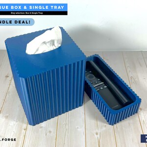 May include: A navy blue square tissue box cover and a matching rectangular tray with a ribbed texture. The tissue box holds white tissues, and the tray contains a black remote control. Text includes TISSUE BOX & SINGLE TRAY, BUNDLE DEAL!, and CD.FORGE.