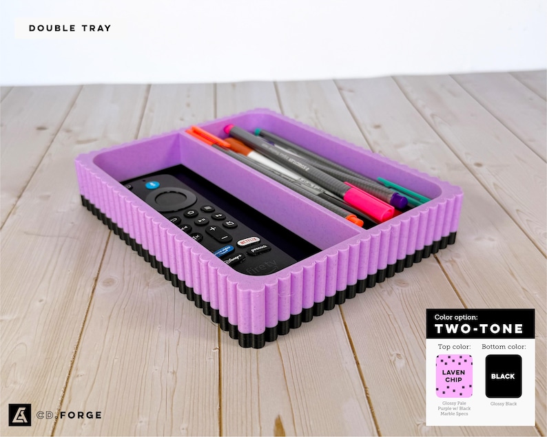 May include: A rectangular double tray with a lavender top and black base featuring a ribbed exterior. The tray contains a black remote control and several colorful pens. Text on the image reads DOUBLE TRAY and TWO-TONE.