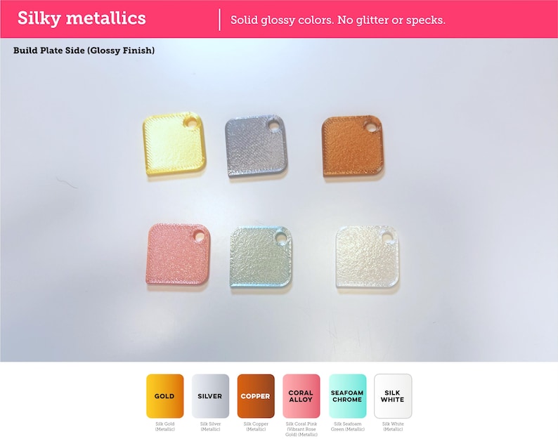 May include: Six square-shaped metallic swatches with rounded corners and a hole in the top right corner. The colors include gold, silver, copper, coral, seafoam green, and white. Text reads: Silky metallics, Solid glossy colors. No glitter or specks, Build Plate Side (Glossy Finish), GOLD, SILVER, COPPER, CORAL ALLOY, SEAFOAM CHROME, SILK WHITE.