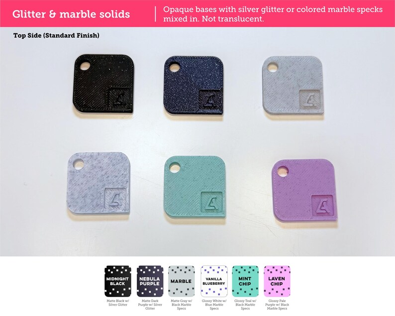 May include: Six square tiles with rounded corners and a circular hole in one corner. Each tile features a small embossed logo. The colors include black, dark purple, gray, light blue, teal, and light purple, with glitter or marble speckles.