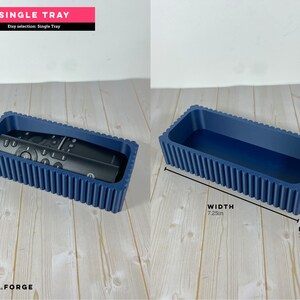 May include: A navy blue rectangular tray with a ribbed exterior texture. The tray measures 7.25 inches in width, 3.25 inches in length, and 1.50 inches in height. One image shows a black remote control resting inside the tray.