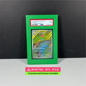 May include: A green frame encases a Pokémon trading card featuring an Ivysaur illustration. The card is graded and labeled with details including "2023 POKEMON MEW EN" and "ILLUSTRATION RARE." Below, a banner reads "DIGITAL STL FILE" and "Commercial license included."