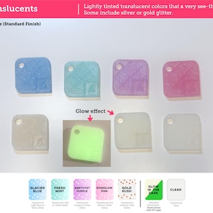 May include: A collection of seven square translucent plastic swatches with rounded corners and a hole in one corner. Colors include light blue, teal, purple, pink, clear with glitter, and a square showing a green glow-in-the-dark effect.