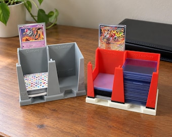 May include: Two plastic trading card organizers with two compartments each, labeled Sleeves and Top Loaders. One organizer is gray, the other is red with a white base. Both hold stacks of card sleeves and rigid plastic top loaders.