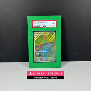 May include: A green 3D-printed display frame holding a PSA-graded 2023 Pokemon Ivysaur trading card. The card features a holographic illustration of the character Ivysaur. The PSA label reads 2023 POKEMON MEW EN IVYSAUR ILLUSTRATION RARE #167 MINT 9.