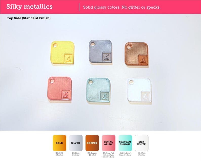 May include: Six square tags with rounded corners and a circular hole, featuring a silky metallic finish in gold, silver, copper, coral alloy, seafoam chrome, and white. Each tag displays a small embossed logo in the bottom right corner.
