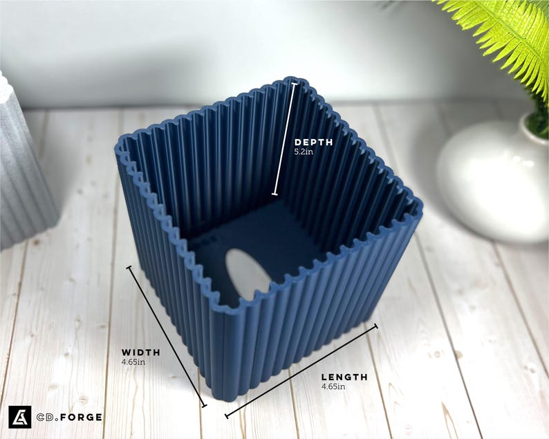 May include: A dark blue square planter with a ribbed exterior texture. The planter features printed dimensions of 4.65 inches in width, 4.65 inches in length, and 5.2 inches in depth. The base includes a drainage hole.