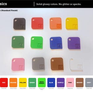 May include: A collection of twelve square plastic tags with rounded corners, each featuring a circular hole and a small embossed logo. The tags are displayed in a grid and come in various solid glossy colors including black, red, orange, yellow, green, neon green, blue, purple, pink, brown, grey, and white.