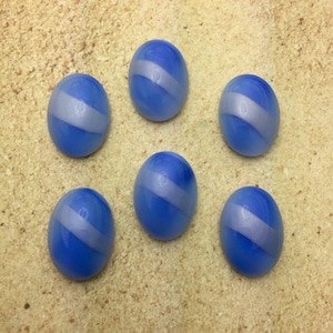 May include: Six oval-shaped buttons with a blue and white swirl pattern. The buttons are made of glass and have a smooth, shiny finish.